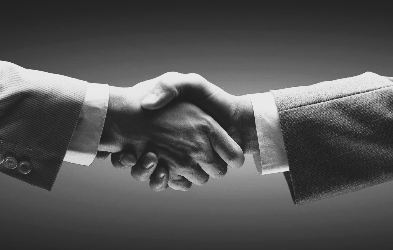 White label and broker agreement symbolized by a professional handshake